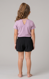 Girls light purple short sleeve boxy tee with keyhole back and black elastic waist shorts.