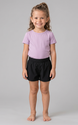 Girls lilac short sleeve shirt paired with black elastic waist shorts, casual summer outfit.