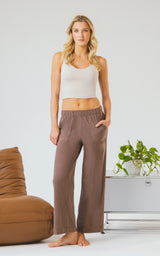 Woman wearing relaxed brown marled pique wide-leg pants with an elastic drawstring waist and straight hems.